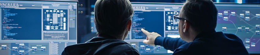 a few men looking at a screen