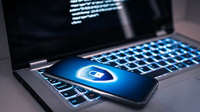 a blue cell phone on a laptop a blue cell phone on a laptop