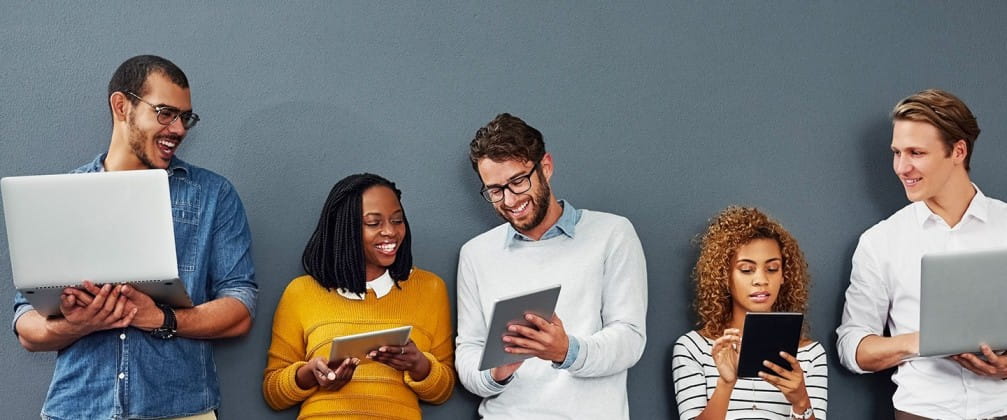 a group of people looking at a laptop