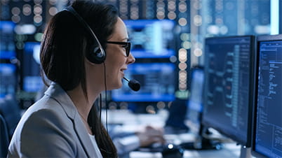 A women wearing glasses and headphone in front of a screen A women wearing glasses and headphone in front of a screen