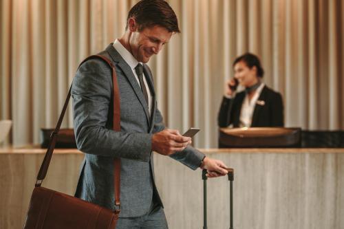 Businessman in hotel lobby on mobile