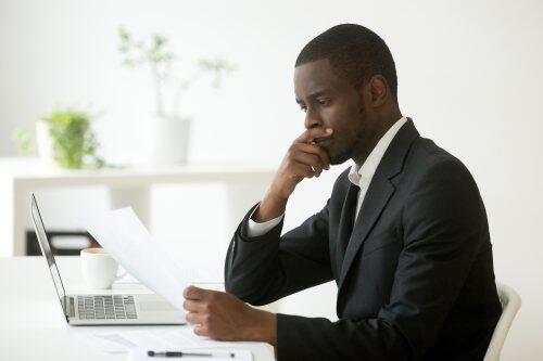 Businessman pondering decision for blog post