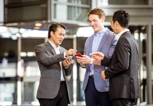 Businessmen on mobile phones in convention center