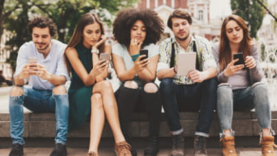 a group of students looking at their phones a group of students looking at their phones