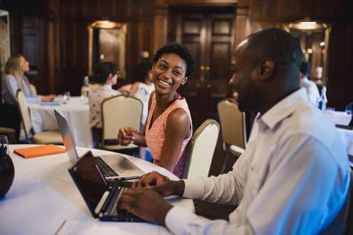 Happy coworkers at business conference for blog post