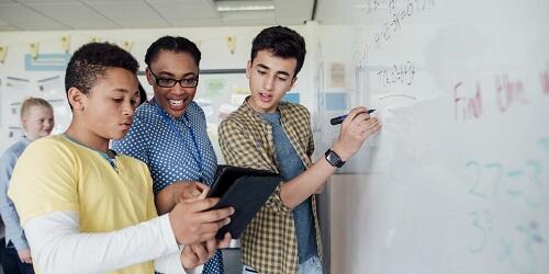 Students with teacher at whiteboard blog