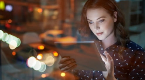 A woman looking at a laptop