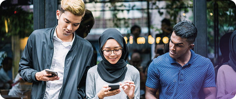 people reading their phones and laughingdigital government 810x340 banner