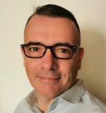 a man wearing glasses and smiling at the camera a man wearing glasses and smiling at the camera