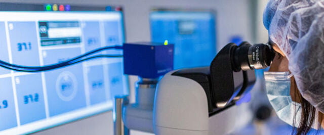 a person in a mask and a mask in a room with blue and white machines