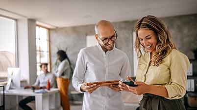 a man and a woman looking at a phone