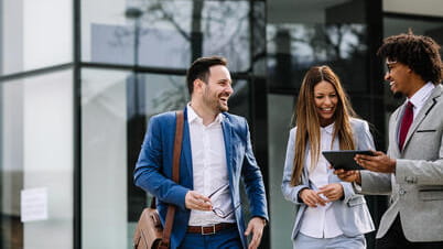 Three people speaking in the street