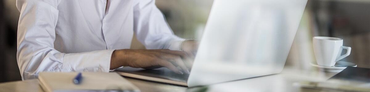 a man typing on a laptop keyboard