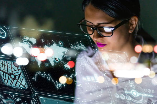Person viewing global maps, charts, and data visualizations on a a digital interface screen