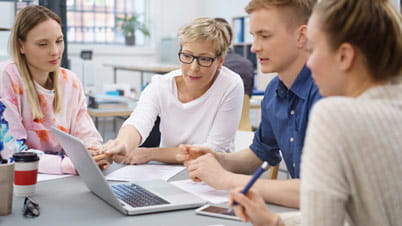 Innovation project university blog image A group of people looking at a laptop.