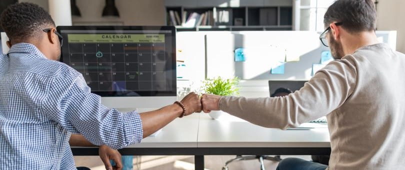 Two men fist-pumping