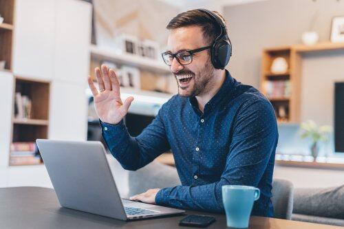 Man waving on video conference call for blog post