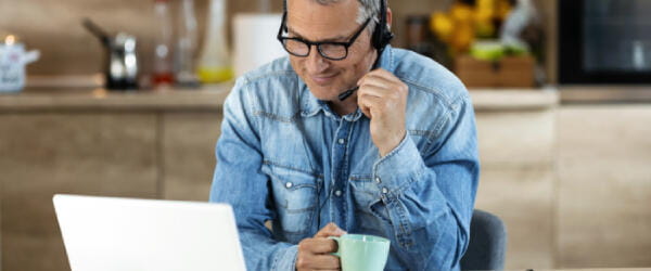 a man wearing headphones and holding a phone to his ear.