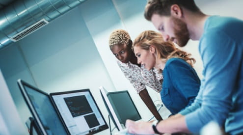 a group of people looking at a computer screen