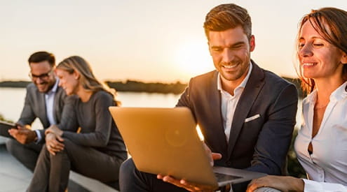 A man and woman looking at a laptop