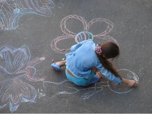 School girl drawing with chalk