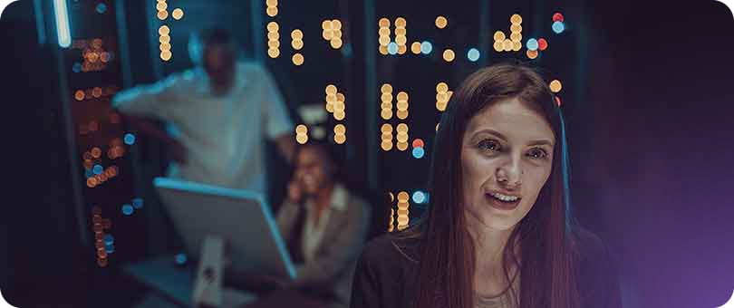Male and female maintenance engineers examining data on digital tablet together in server room.
