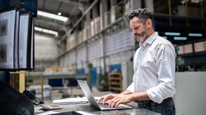 A man looking at a laptop images
