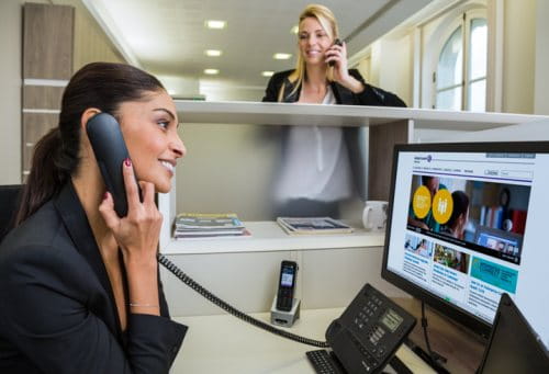 Business women using traditional business telephony