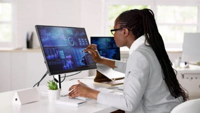 A Woman looking at a laptop