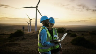 A man and woman at a wind farm