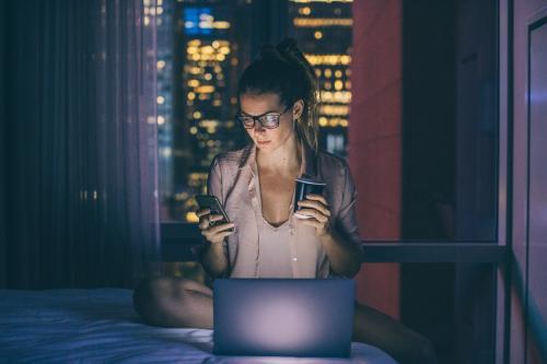 Woman on laptop in hotel room